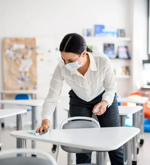 Cleaning a classroom desk